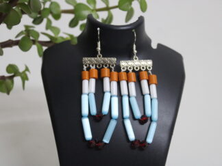 Modern and sleek earring with silver bar, small brown, glossy white and light blue pipes | four strings and small red octagon beads